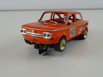 Lot 198 - A group of 1:32 scale slot racing cars by...