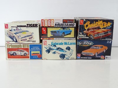 Lot 208 - A group of 1:25 scale plastic car kits by AMT...