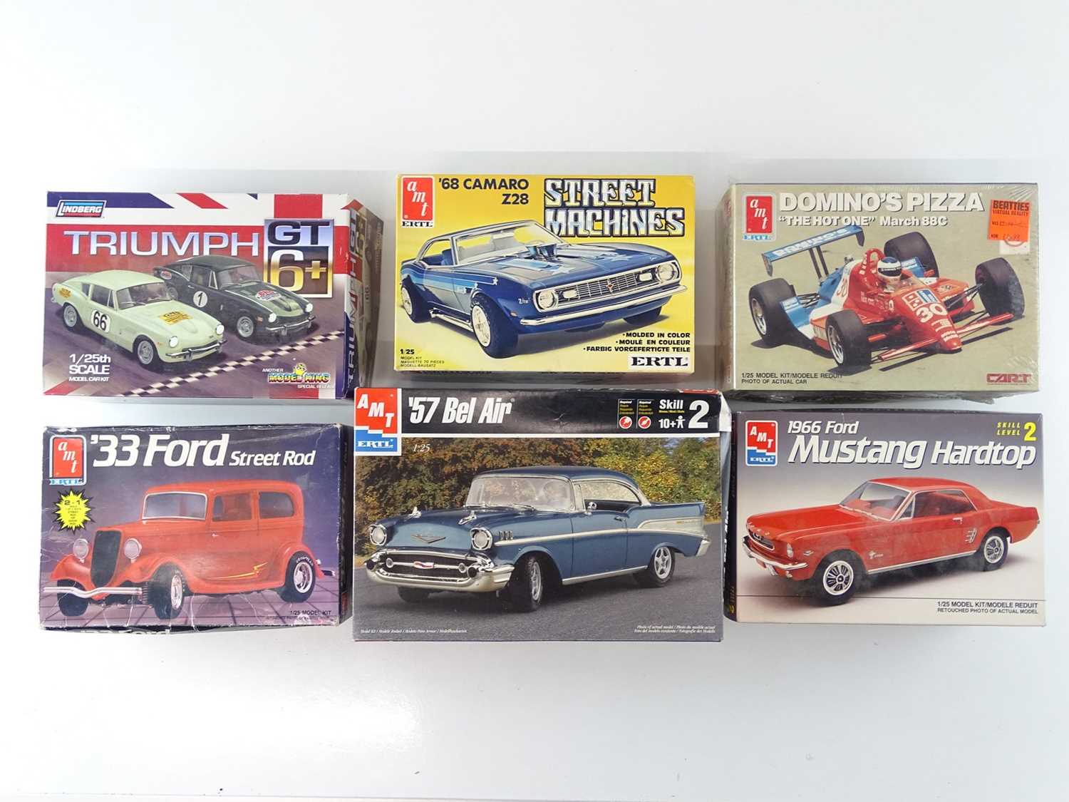 Lot 210 - A group of 1:25 scale plastic car kits by AMT...