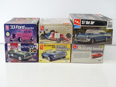 Lot 210 - A group of 1:25 scale plastic car kits by AMT...