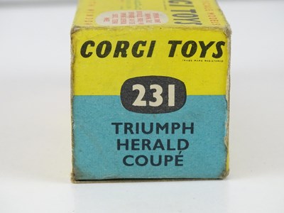 Lot 9 - A CORGI 231 Triumph Herald Coupe in gold/white...