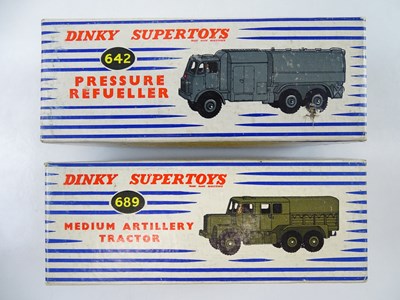 Lot 144 - A pair of DINKY military trucks comprising a...