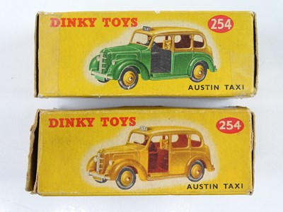 Lot 155 - A pair of DINKY 254 Austin Taxis comprising...