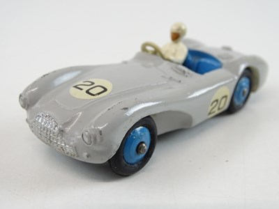 Lot 85 - A pair of DINKY Aston Martins comprising a 104...