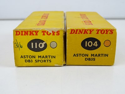 Lot 85 - A pair of DINKY Aston Martins comprising a 104...