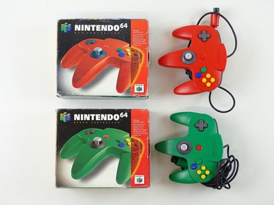 Lot 71 - A pair of Nintendo 64 N64 controllers, one red...