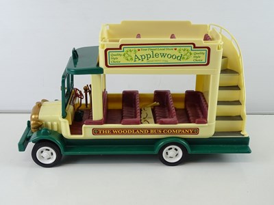 Lot 244 - A group of SYLVANIAN FAMILIES bus, vans,...