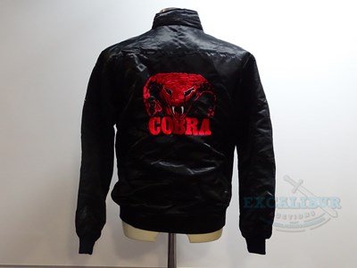 Lot 251 - COBRA (1986) - A black crew jacket with red...