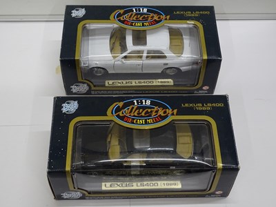 Lot 156 - A group of boxed 1:18 scale diecast cars by...