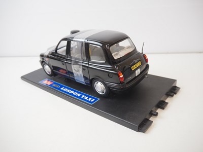 Lot 126 - A pair of diecast taxis - comprising of a...
