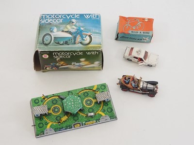 Lot 69 - A small group of toys, comprising a clockwork...
