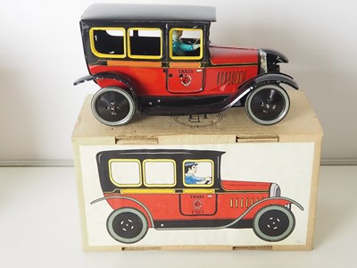 Lot 70 - A group of plastic and tin plate models of...