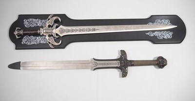 Lot 166 - A pair of replica film swords to include a...