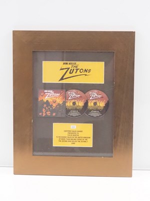 Lot 689 - ZUTONS - A framed and glazed BPI award for...