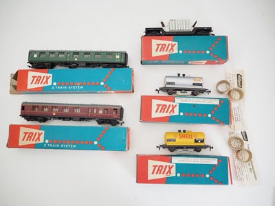 Lot 384 - A group of TRIX OO gauge coaches and wagons as...