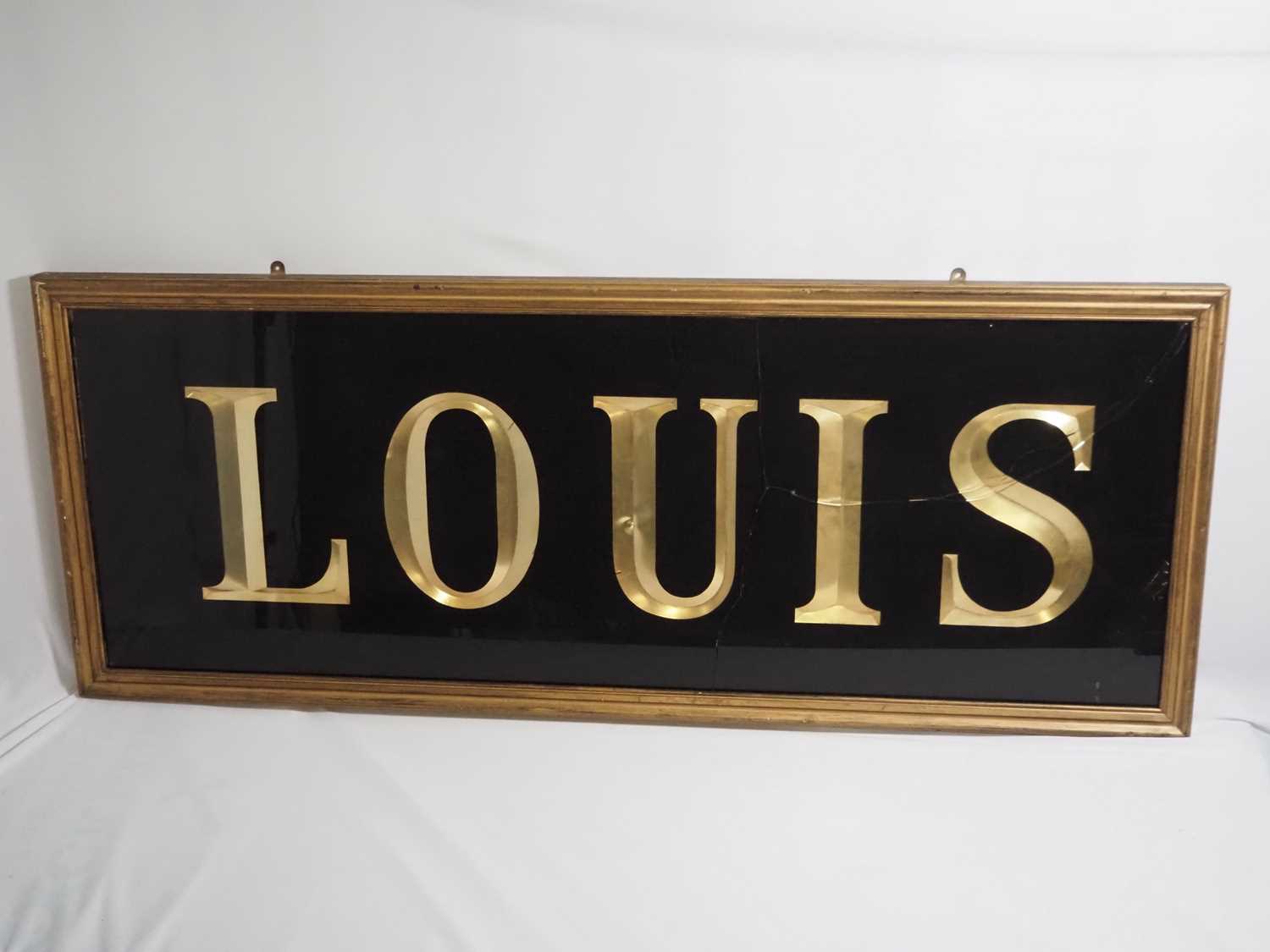 Lot 257 - A framed and glazed sign reading 'Louis',