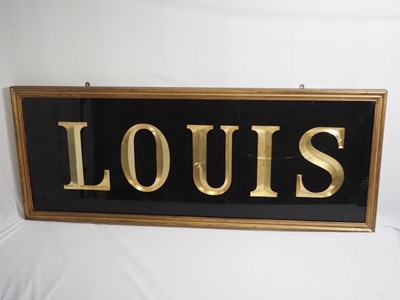 Lot 257 - A framed and glazed sign reading 'Louis',...