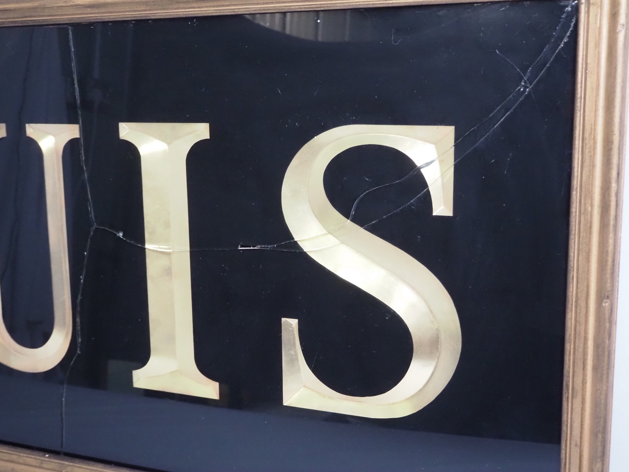 Lot 257 - A framed and glazed sign reading 'Louis',
