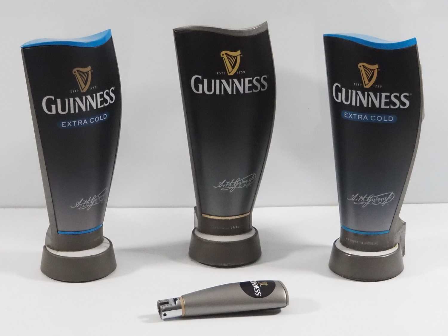 Lot 391 - A group of 3 Guinness beer pump covers, Two of...