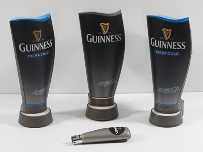 Lot 391 - A group of 3 Guinness beer pump covers, Two of...