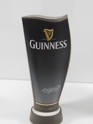 Lot 391 - A group of 3 Guinness beer pump covers, Two of...