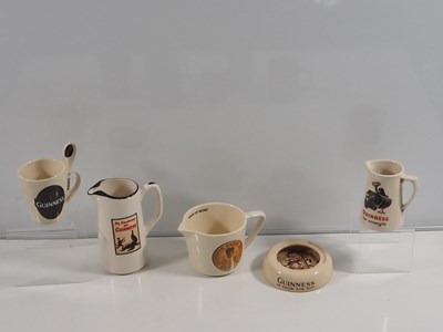 Lot 412 - A collection of Guinness mugs, water jugs,...