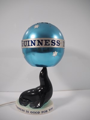 Lot 404 - GUINNESS: Carlton Ware Sealion Lamp with...