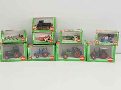 Lot 85 - A group of SIKU 1:32 scale diecast tractors,...