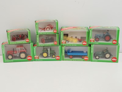 Lot 86 - A group of SIKU 1:32 scale diecast tractors,...