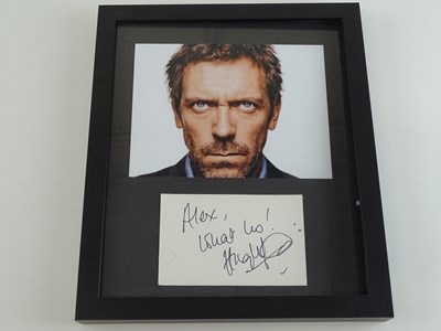 Lot 121 - A framed and glazed photograph of HUGH LAURIE...