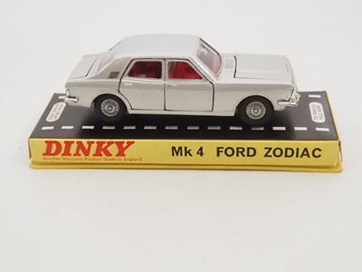 Lot 114 - A pair of DINKY diecast cars in original hard...