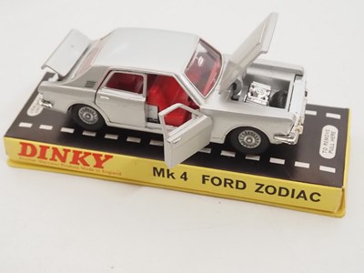 Lot 114 - A pair of DINKY diecast cars in original hard...