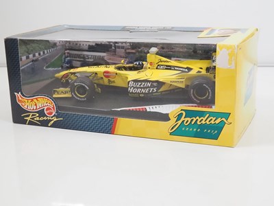 Lot 4 - A pair of diecast 1:18 and 1:24 Formula 1...