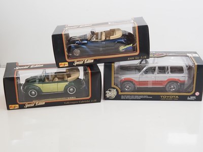 Lot 69 - A group of 1:18 scale diecast cars by TCHIBO,...