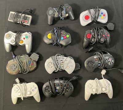 Lot 397 - CONTROLLERS - A group of unboxed video game...