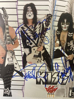 Lot 527 - A KISS 2010 Sonic Boom tour photo card signed...