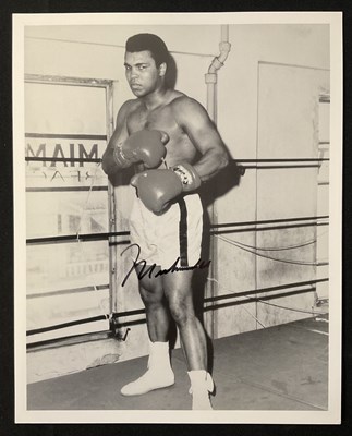 Lot 569 - MUHAMMAD ALI - An autographed 8" x 10" black...