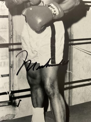 Lot 569 - MUHAMMAD ALI - An autographed 8" x 10" black...