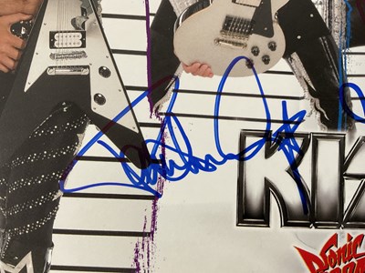 Lot 509 - A KISS 2010 Sonic Boom tour photo card signed...