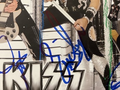 Lot 509 - A KISS 2010 Sonic Boom tour photo card signed...