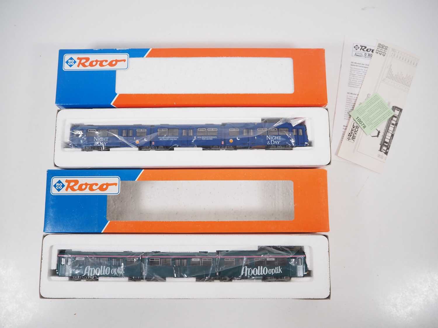 Lot 23 - A pair of ROCO HO gauge 3-car Duwag tram cars...