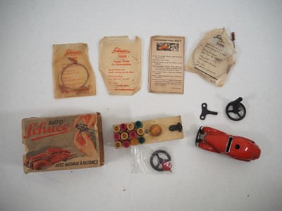 Lot 305 - A SCHUCO 3000 tinplate clockwork car with tele...