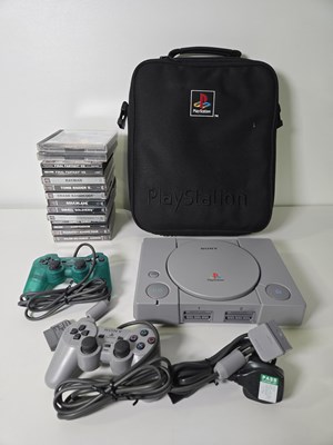 Lot 644 - A Playstation 1 console with Playstation carry...