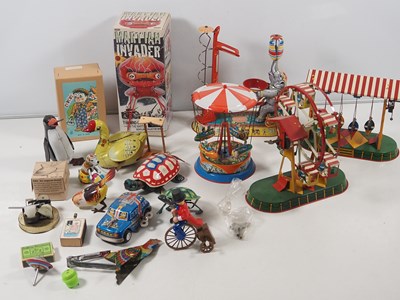 Lot 490 - A group of boxed and unboxed tinplate toys,...