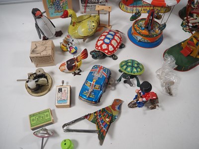 Lot 490 - A group of boxed and unboxed tinplate toys,...
