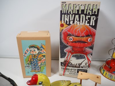 Lot 490 - A group of boxed and unboxed tinplate toys,...