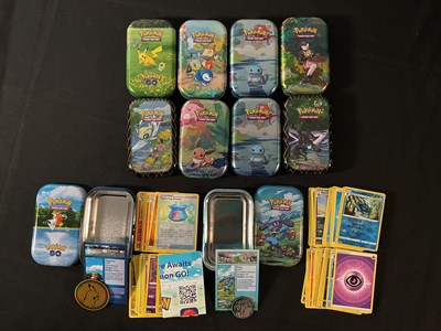 Lot 523 - A collection of 10 tins of Pokémon cards from...