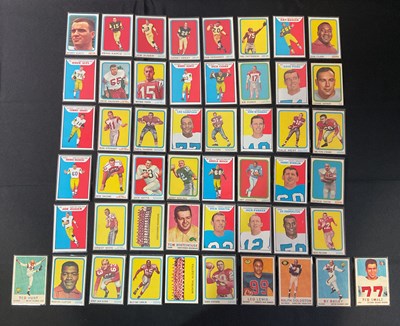 Lot 448 - A collection of 50 vintage Topps NFL trading...