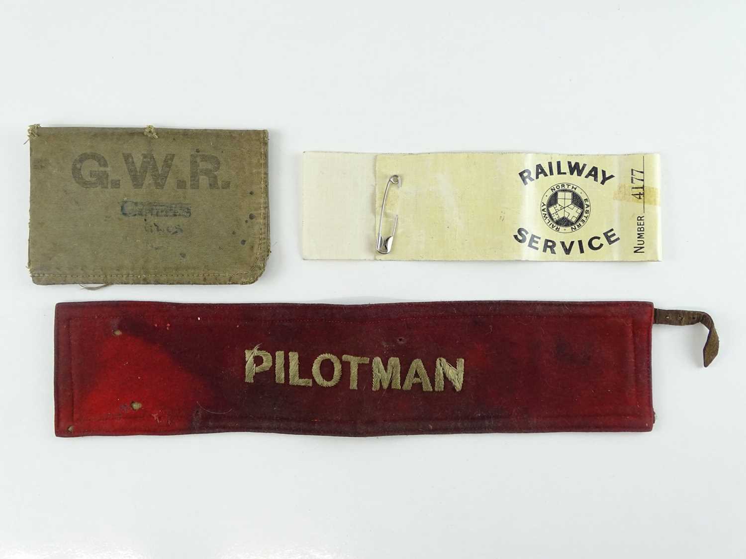 Lot 40 - A pair of armbands comprising: a Pilotman band...