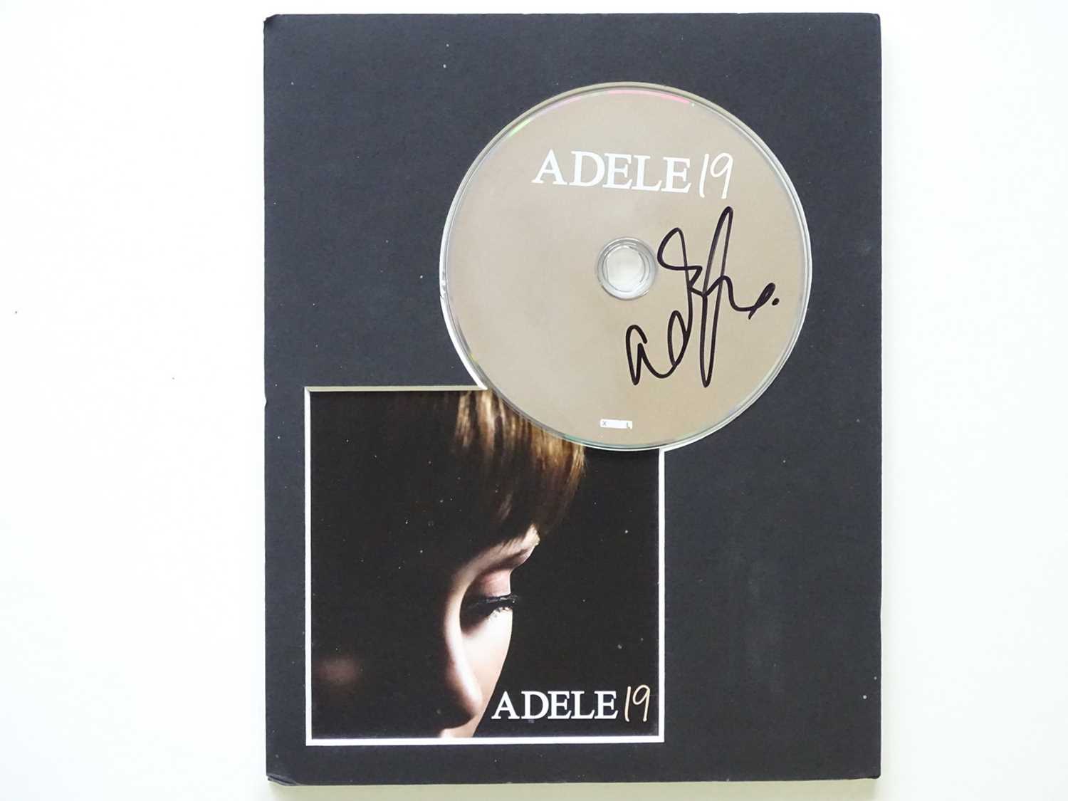 Lot 455 - A mounted CD and cover '19' signed by ADELE